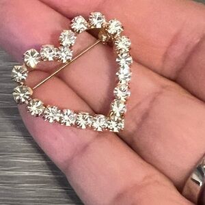 Paved clear CZ heart brooch in gold tone